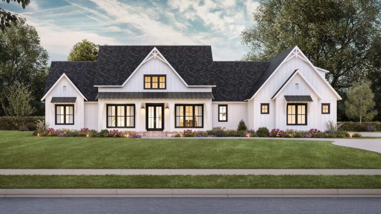 A front view of a modern farmhouse-style home with a sleek and contemporary design. The exterior features white board and batten siding, a dark shingled roof, and black metal awnings above the windows. The home has a large, covered front porch supported by white columns, leading to a set of double front doors with glass panels. The porch is framed by large windows, enhancing the natural light inside. Above the porch, a central gable with a window adds architectural interest to the roofline. The front yard is beautifully landscaped with a lush green lawn, colorful flower beds, and shrubs, with mature trees providing a serene backdrop under a partly cloudy sky.